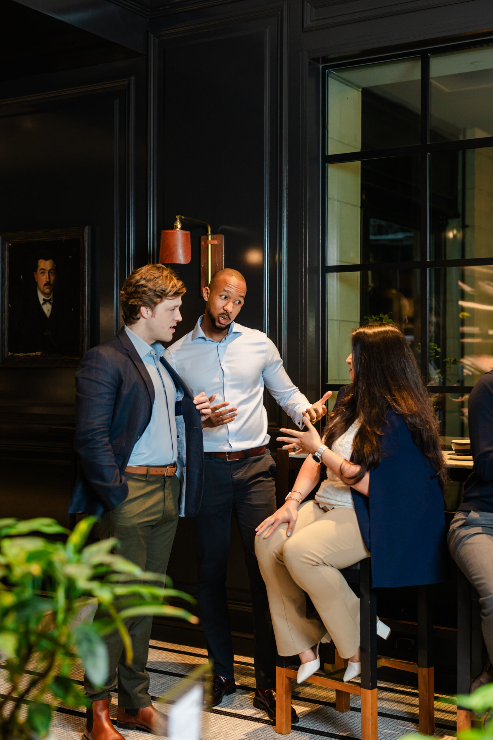 a group of co workers talking to each other in the adolphus hotel 