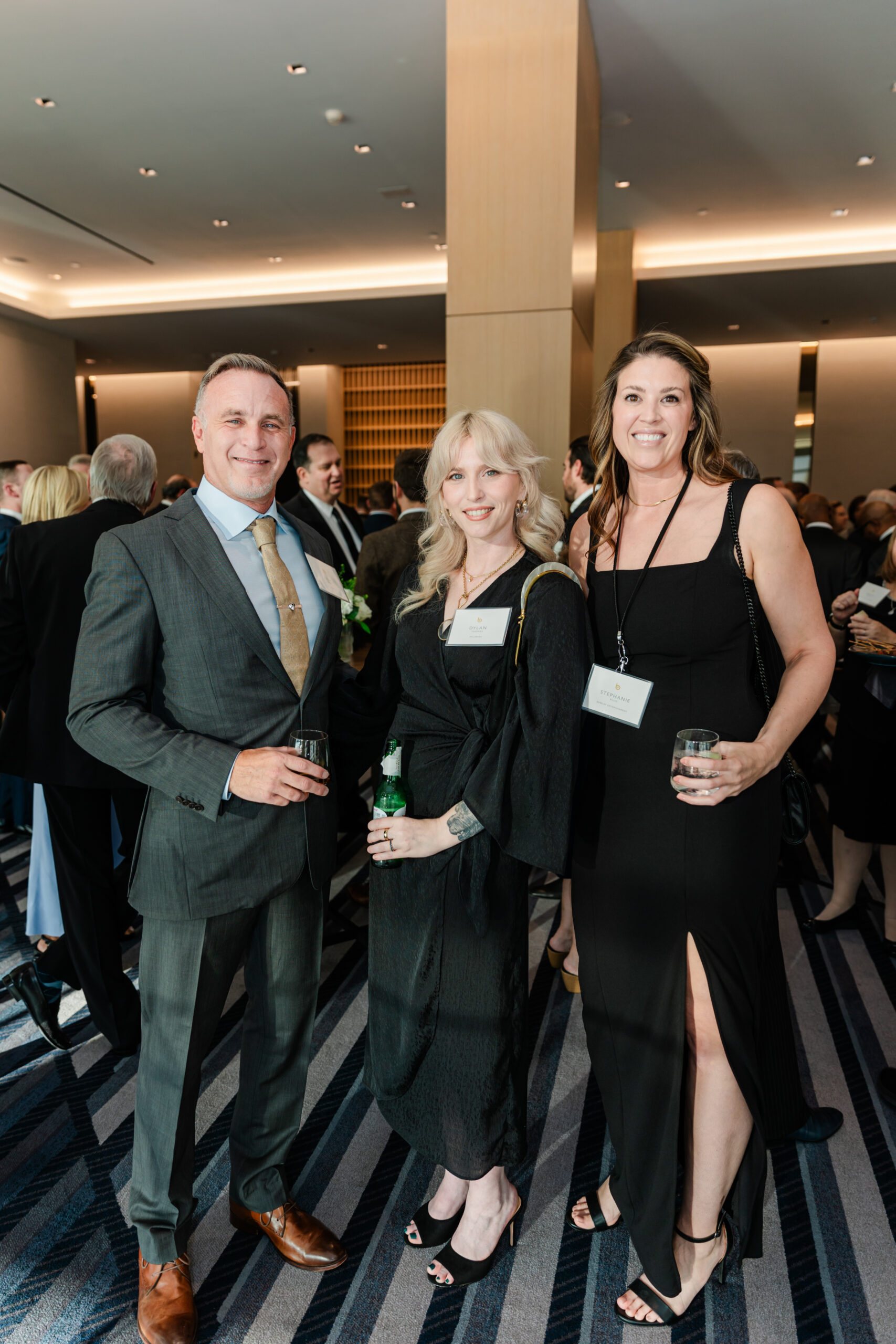 a group of people taking a photo at a corporate celebration for berkley entertainment at the jw marriott dallas