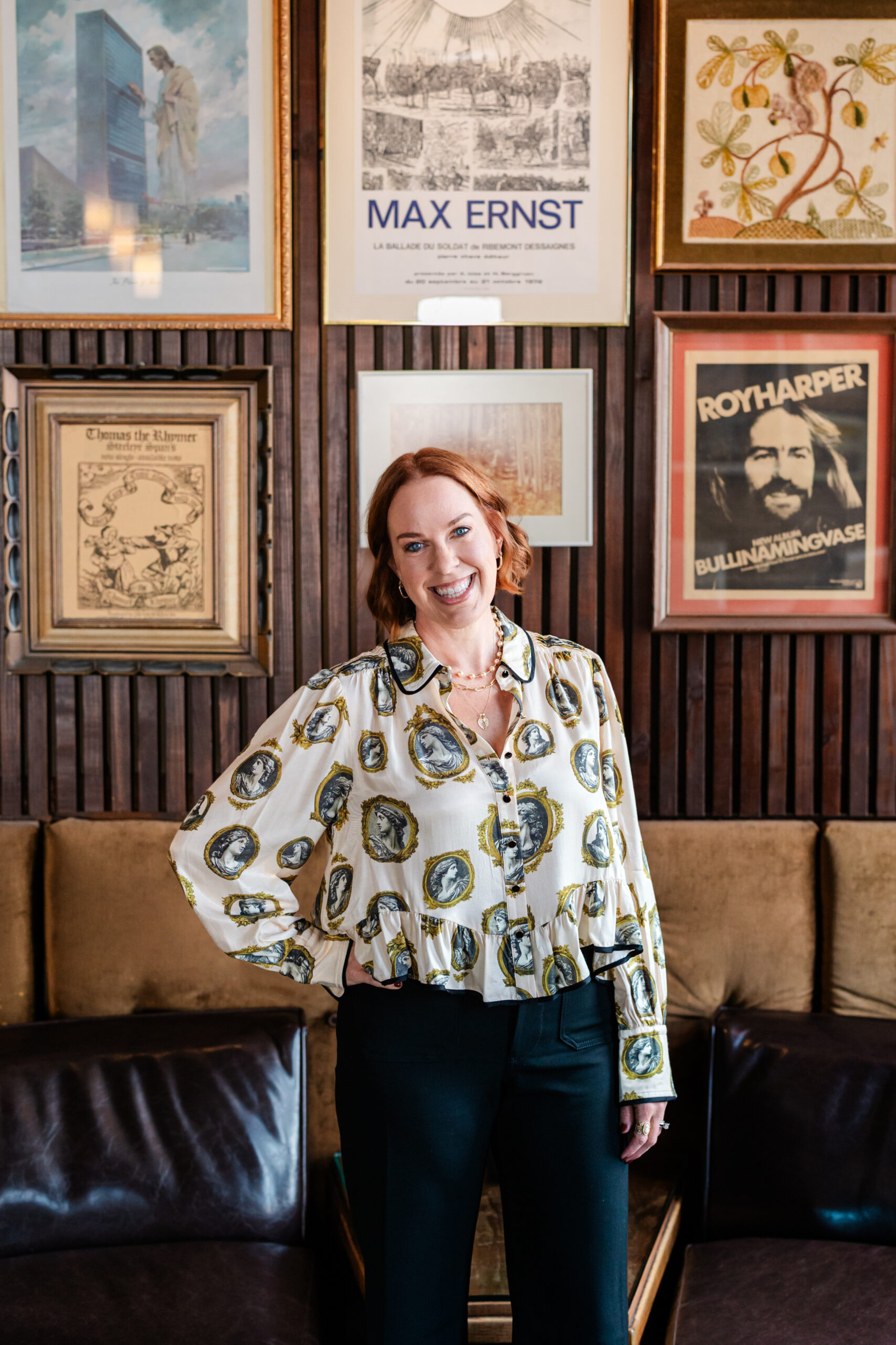 an author taking author headshots inside Paschall's Denton in Dallas the woman is standing with a hand on her hip in front of a couch 