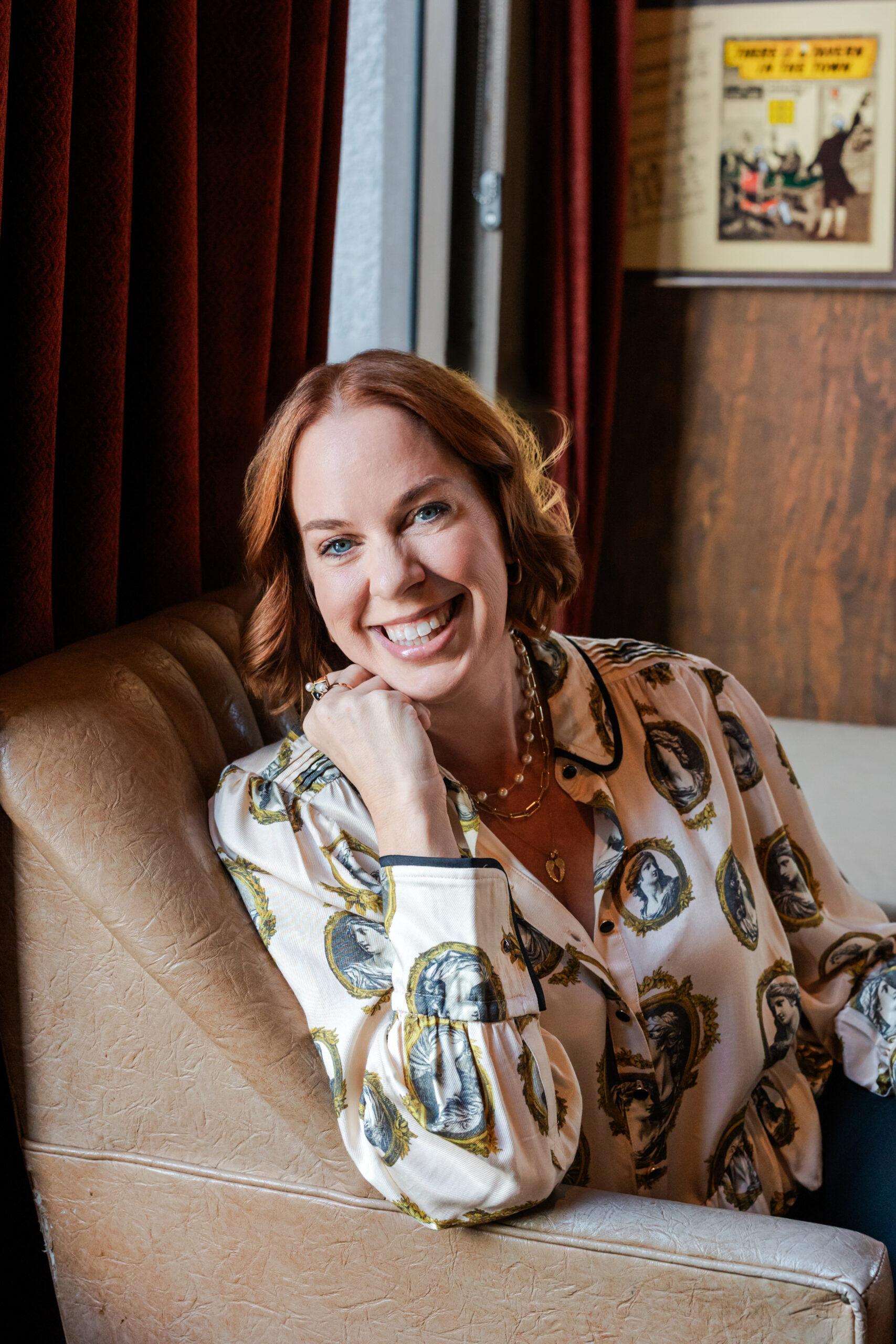an author taking author headshots inside Paschall's Denton in Dallas the woman is sitting on a leather chair 
