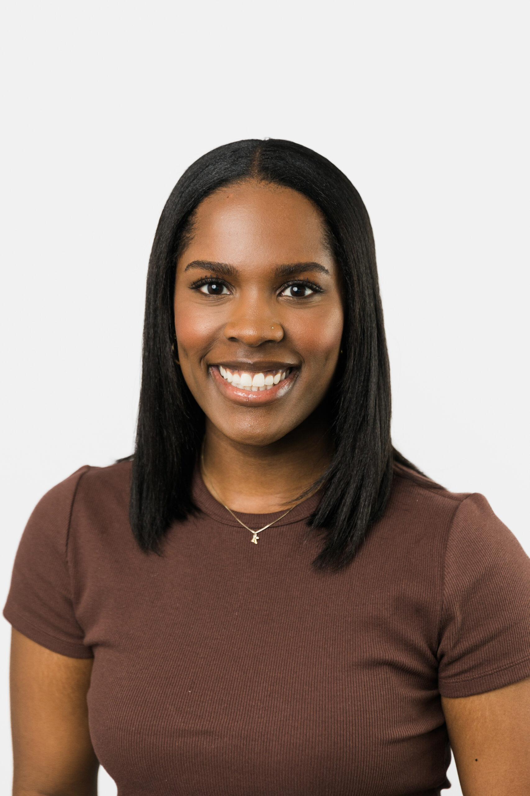 a woman taking a professional headshot in front of a white backdrop 