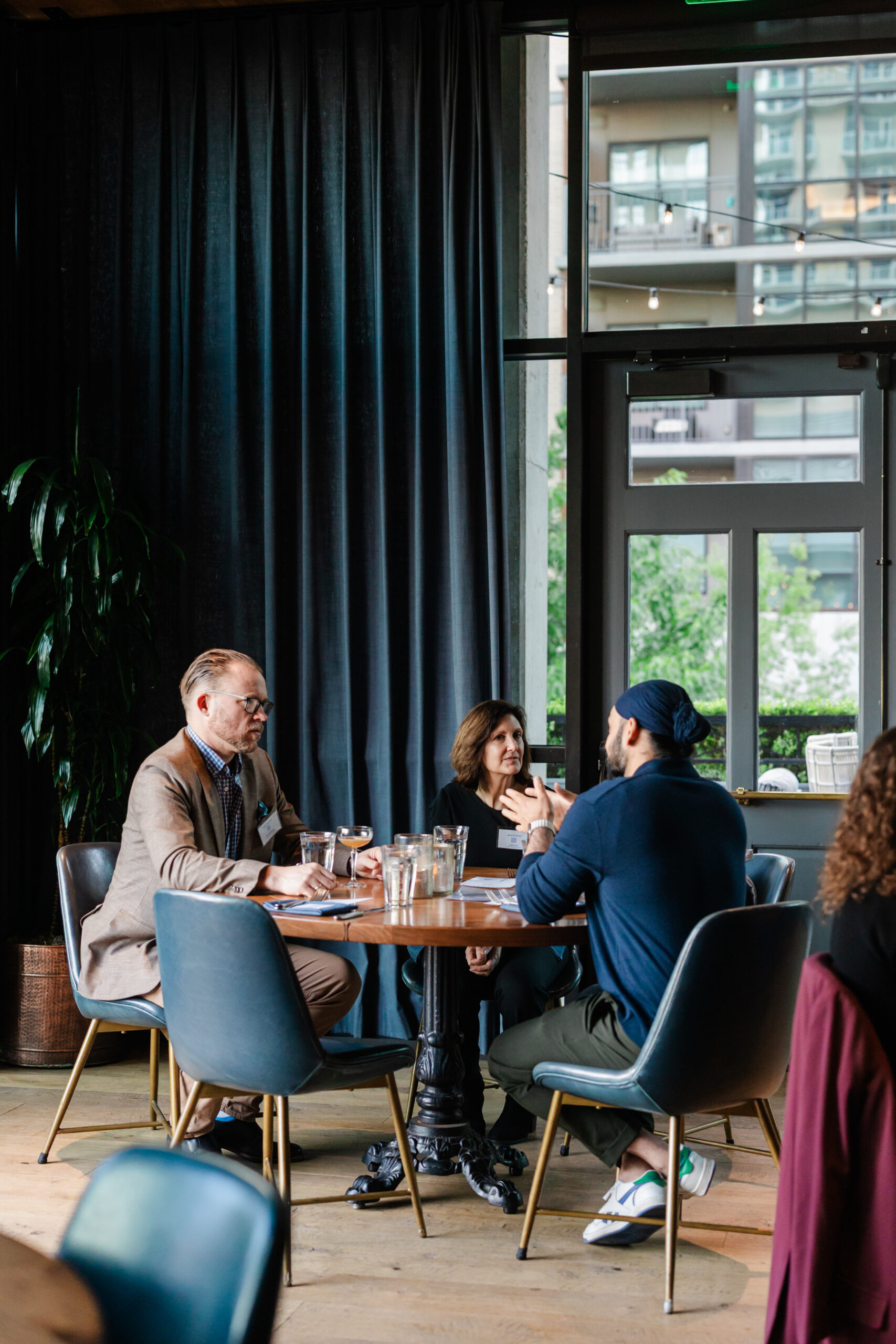 guests having a discussion at a table at a corporate networking event in dallas