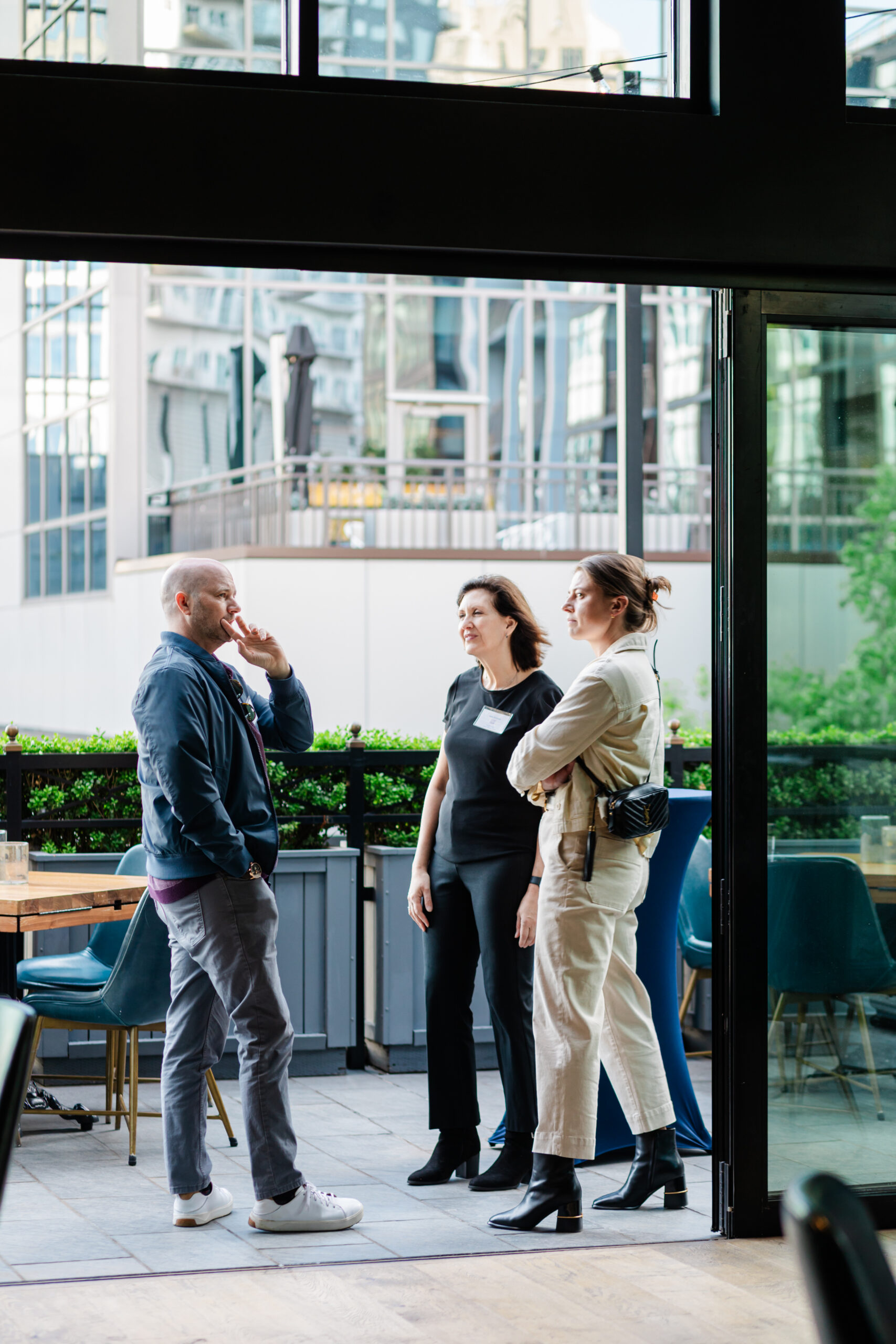 guests at a corporate networking event having a discussion on the patio of the henry