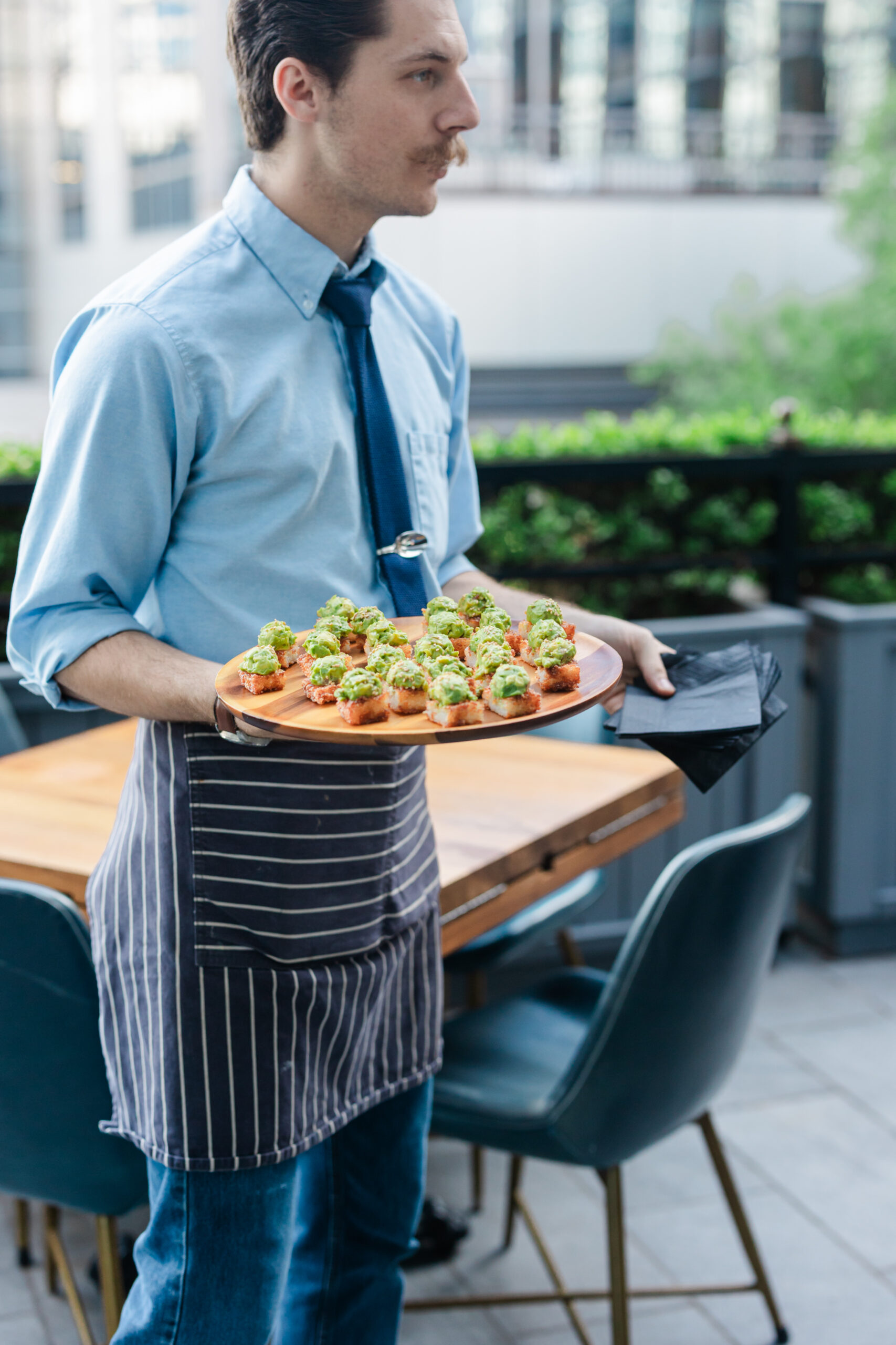 a waiter serving food at the henry in dallas for a corporate networking event