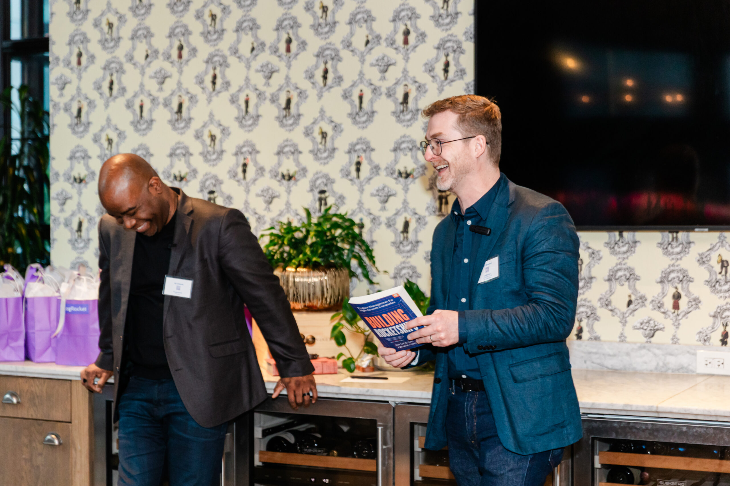 the two founders of logrocket giving a presentation at the henry in dallas at their corporate networking event