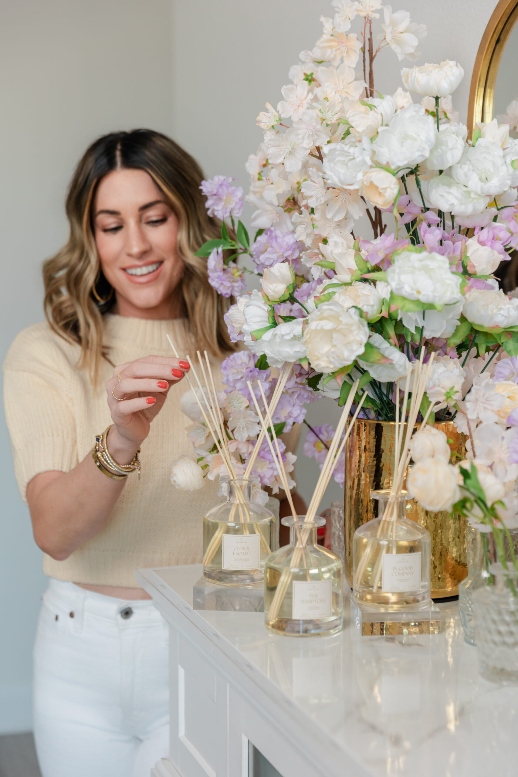 the founder of Life In Lilac during a product branding photography session looking at their diffusers