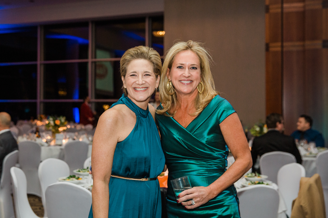 Dallas Nonprofit Event Photographer; two women in dresses smiling and posing for a photo at a nonprofit event.