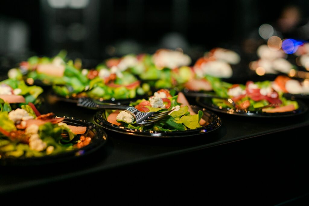 A focused image of the event dinner salads with a fork resting on the vegetable greens