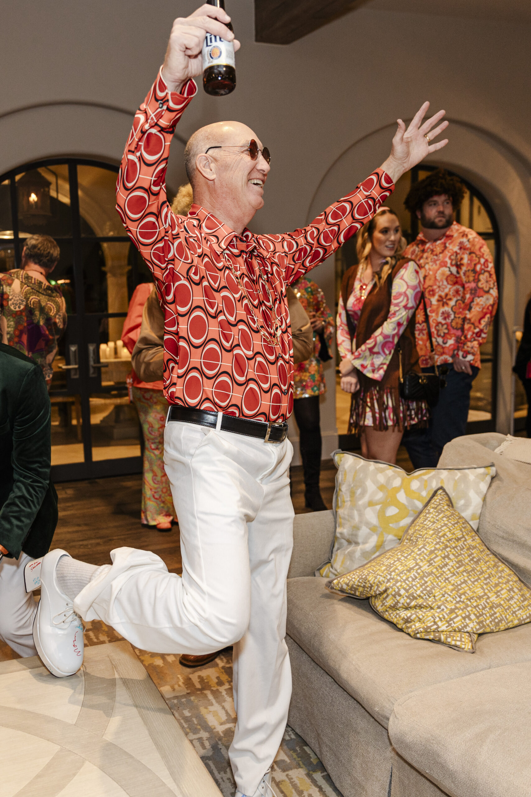 a man celebrating at his birthday party and holding a beer