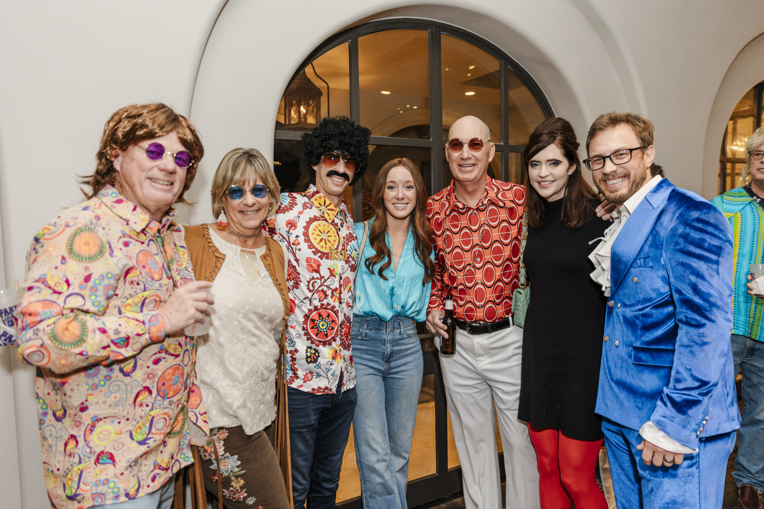 a group taking an image at a 60's themed birthday party in dallas texas