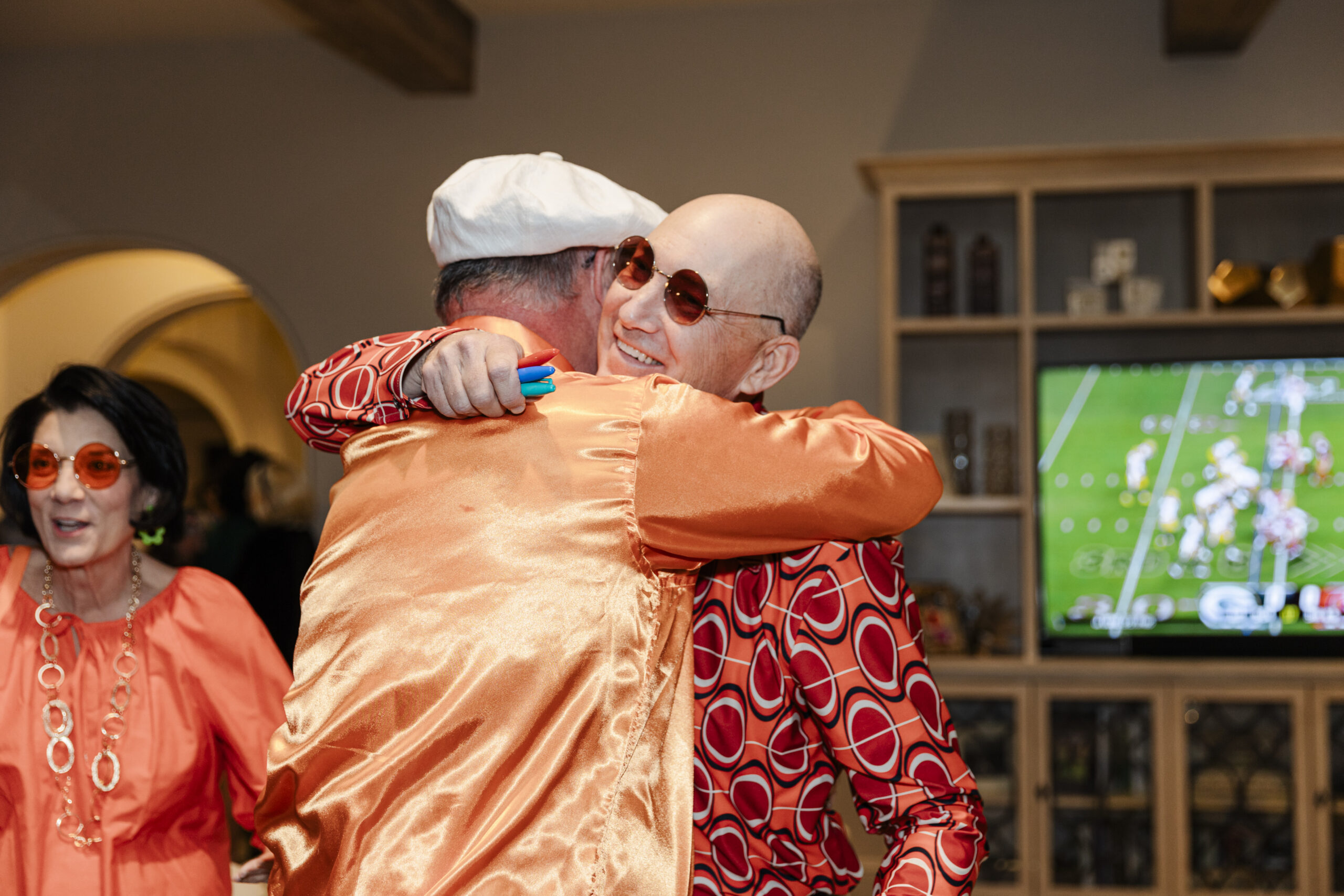 a man hugging his friend at a birthday party