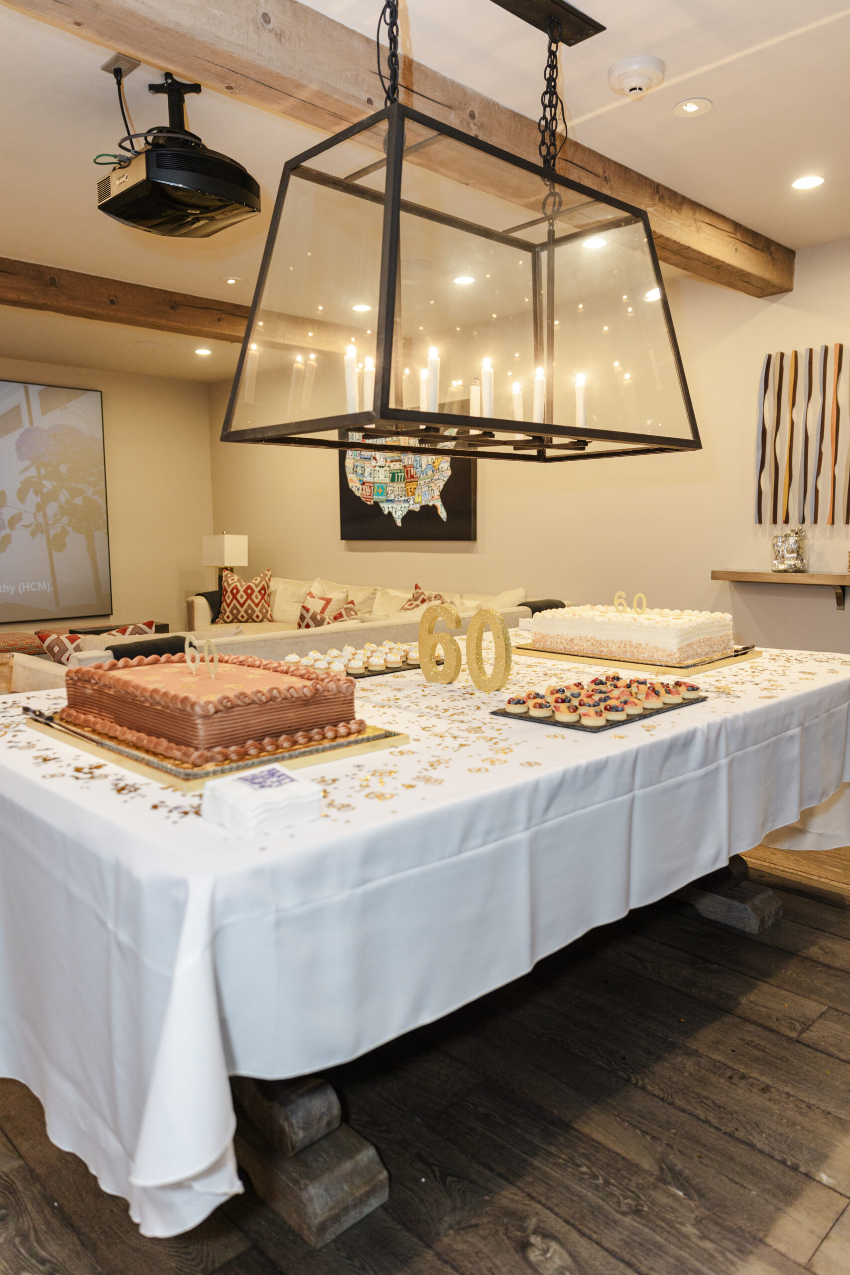 a table decorated for a birthday party with candles and cakes