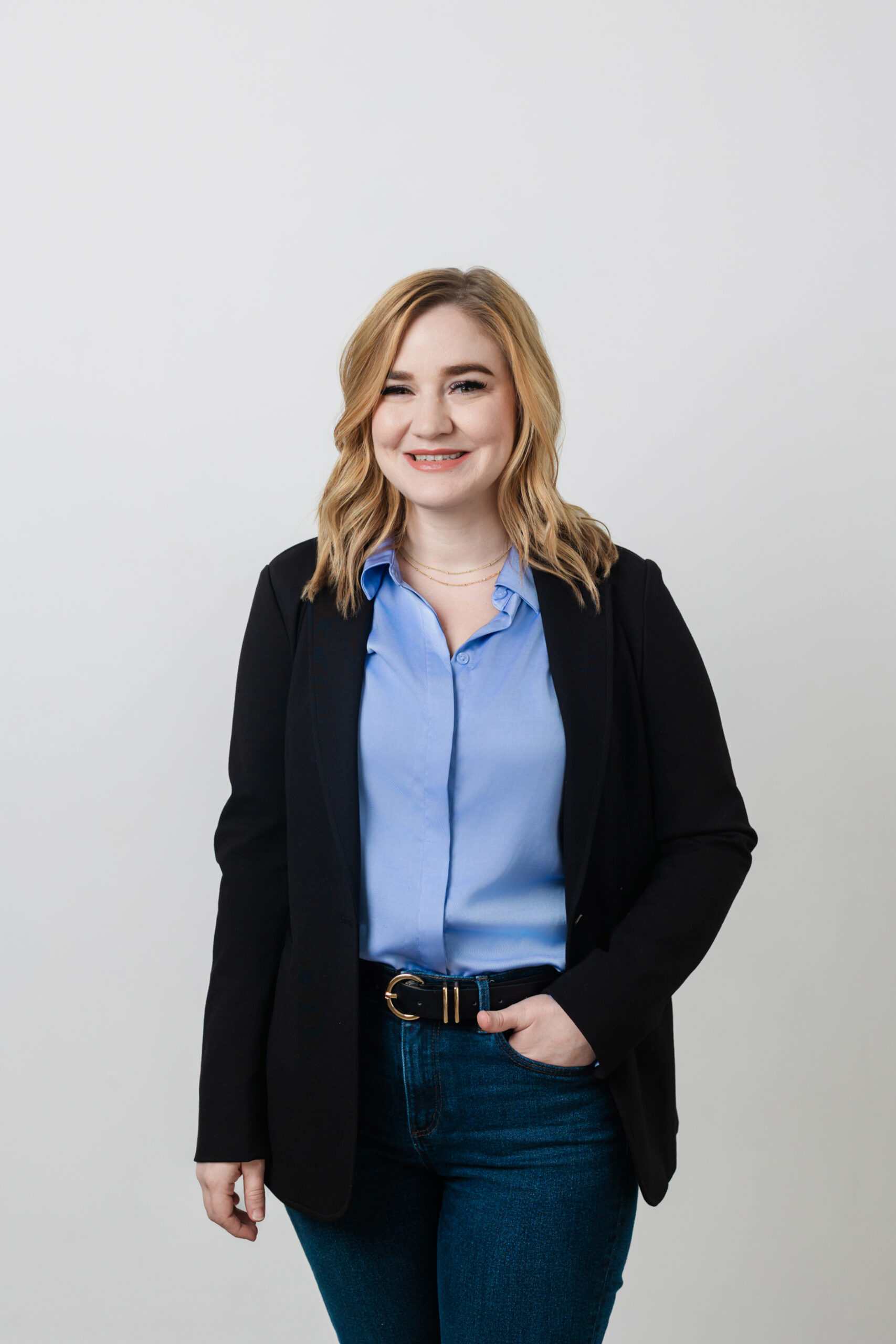 a woman wearing professional attire taking a headshot